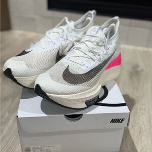 Nike Men’s Air Zoom Alphafly Next %. White and Black Sneakers with Pink Accents